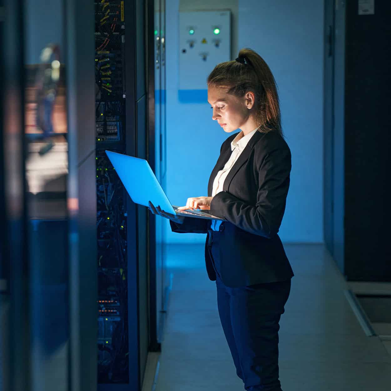 Header Side View Of Woman Using Computer In Server Room