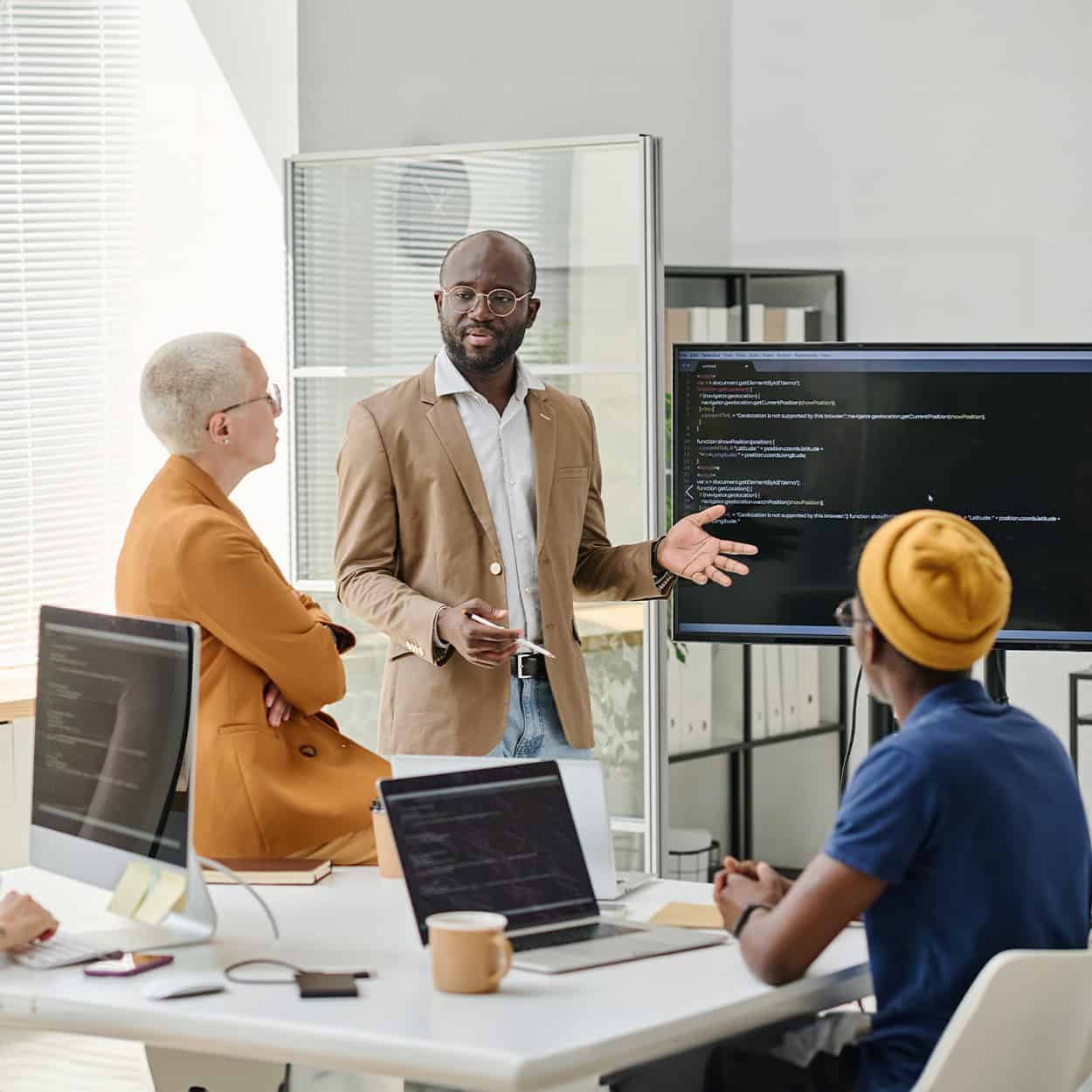 Header Front View Of Man Presenting To Group Of Programmers