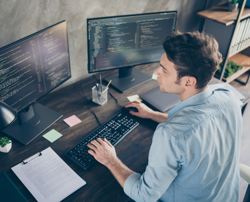 Top Down View Of Male It Professional Working At Desk